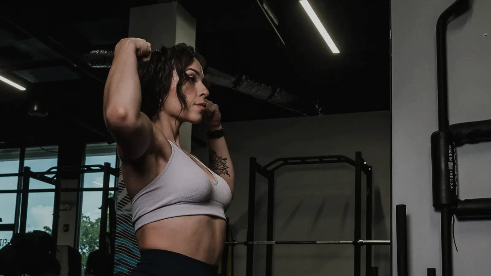 Woman tying her hair up before training